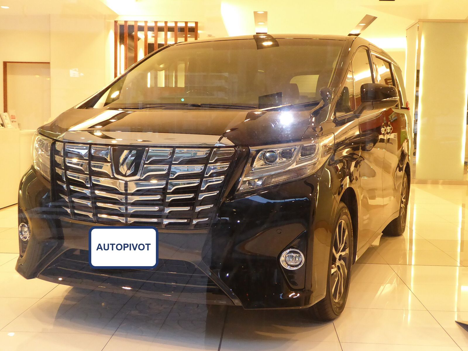 Black Toyota Alphard Hybrid in a Japanese showroom