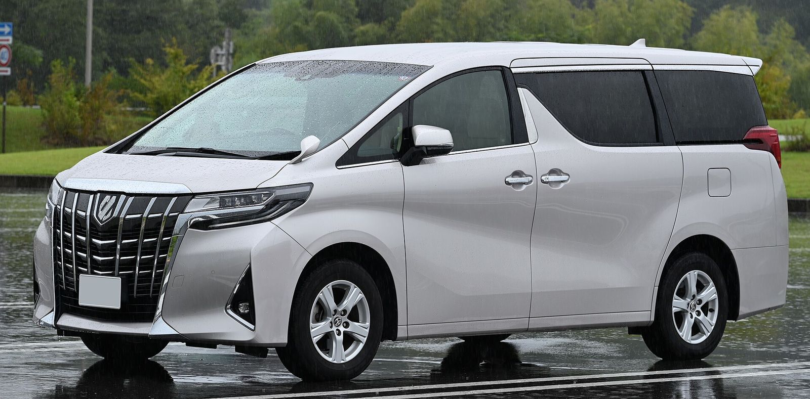 Silver Toyota Alphard on a wet road